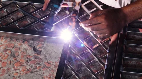 Close up of worker welding metal frame by wielding machine video. 4K. Stock Footage 276468883