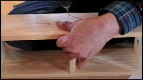 Close up of worker, wood drill and wooden stool construction Stock Footage 49526345
