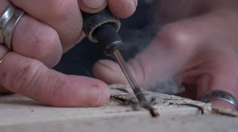 Close-up of worker's hand with tools hacking wood Stock Photos