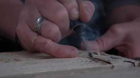 Close-up of worker's hand with tools hacking wood Stock Photos