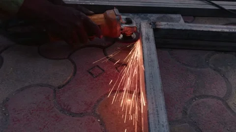 Close up of a workers hand using an angle grinder on metal with sparks flying Stock Footage 262020786