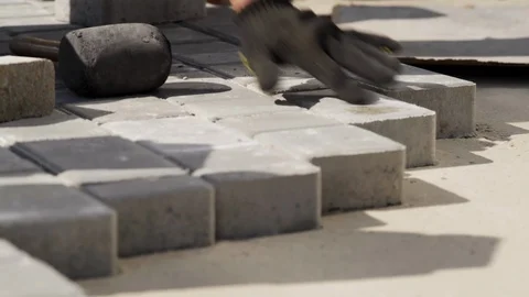 Close-up, Worker's Hands With Gloves Skillfully Lay Paving Slabs Stock Footage 119790733