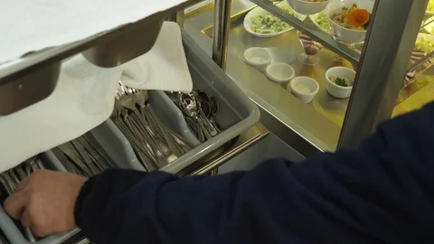 Close-up, worker's hands take bread, cutlery, napkins in the self-service Stock Footage 103578892