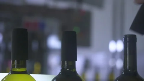 Close-up Of Workers Putting Caps On Wine Bottles In A Factory. 120 fps Stock Footage 155458256