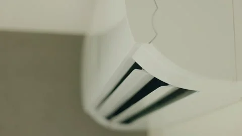 Close-up of a working air conditioner with open airflow flaps blowing cool air Stock Footage 312262223