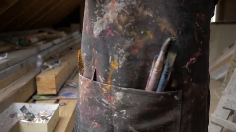 Close-up of the working apron of the artist, in the pockets of which lie the Stock Footage 96376548