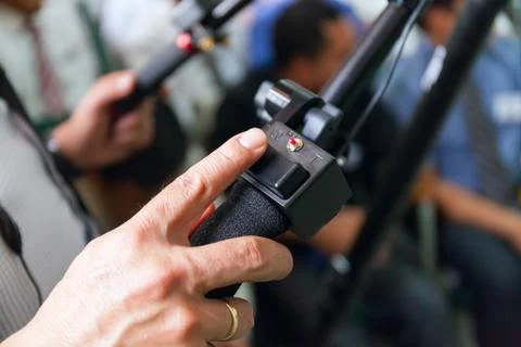 Close-up of working camera of man hand, operator at work. in the hall full of Stock Photos