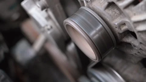 Close-up of a working car engine alternator pulley Stock Footage 327402881
