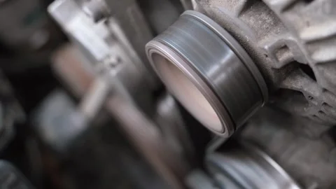 Close-up of a working car engine alternator pulley Stock Footage 327403357