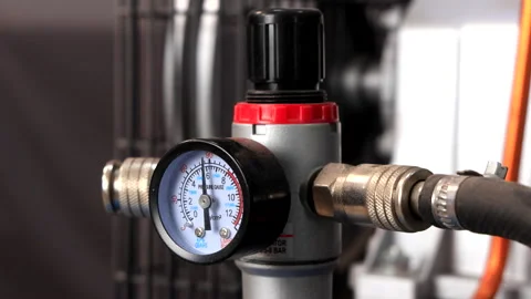 Close-Up of Working Compressor with Pressure Gauge and Rotating Air Blower Stock Footage 288753121