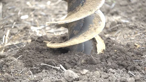 Close up of a working drill, digging a hole in the ground Stock Footage 102493868