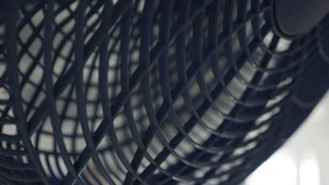 A close-up of a working fan swinging from side to side. The repetitive motion Stock Footage 314119284