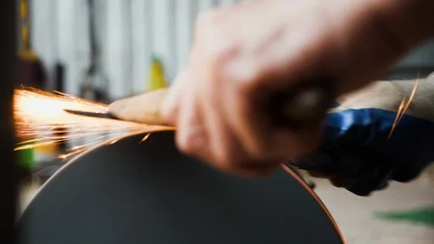 Close up of working man sharpening flat piece of steel for knife preparation Stock Footage 147371442