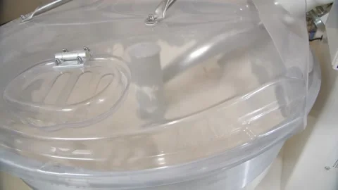 Close-up of working mixer with closed transparent lid as a part a dough machine Stock Footage 204850698