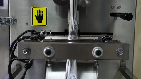 Close-up of the working process of a technical, metal device that creates food Stock Footage 132352561