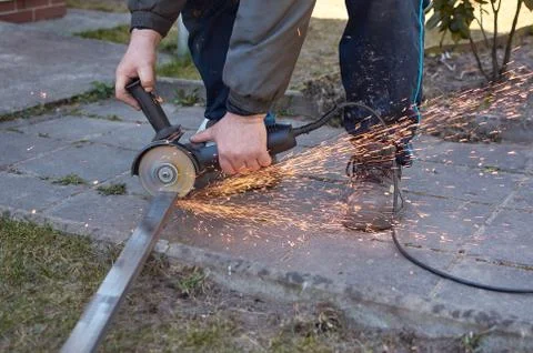 Close-up of the working process, using an electric angle grinder, they cut a  Stock Photos