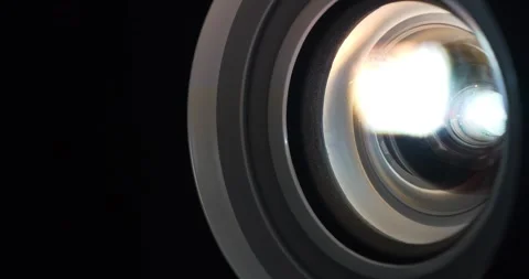Close-up of working projector lens. Cinema hall.Movie is shown through projector Stock Footage 280406223
