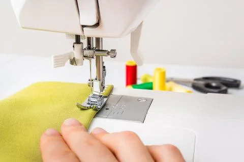 Close-up of working sewing machine foot with green cloth Foto stock