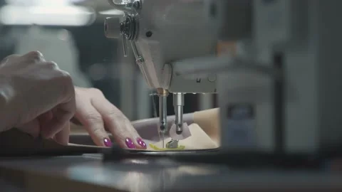 Close up working on sewing machine stitching side of fabric on a sewing machine Stock Footage 231014902