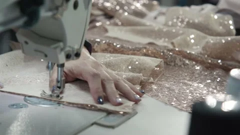 Close up working on sewing machine stitching side of fabric on a sewing machine Stock Footage 231014904