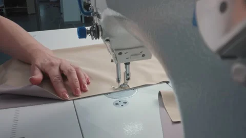 Close up working on sewing machine stitching side of fabric on a sewing machine Stock Footage 231015082