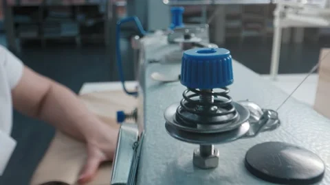 Close up working on sewing machine stitching side of fabric on a sewing machine Stock Footage 231015094