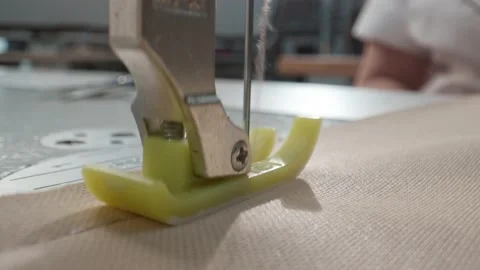 Close up working on sewing machine stitching side of fabric on a sewing machine Stock Footage 231015115