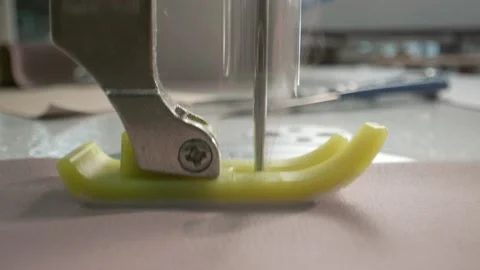 Close up working on sewing machine stitching side of fabric on a sewing machine Stock Footage 231015116