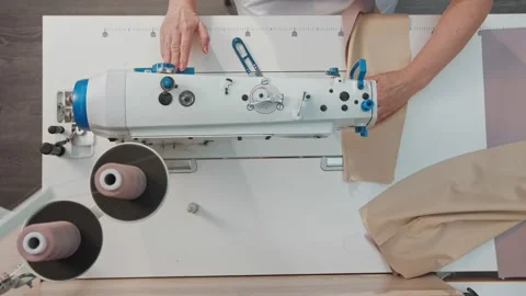 Close up working on sewing machine stitching side of fabric on a sewing machine Stock Footage 231015194