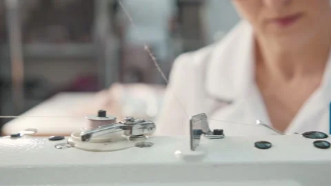 Close up working on sewing machine stitching side of fabric on a sewing machine Stock Footage 231015205