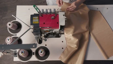 Close up working on sewing machine stitching side of fabric on a sewing machine Stock Footage 231015292