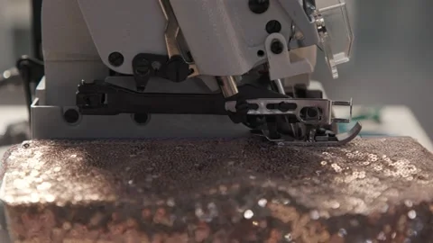 Close up working on sewing machine stitching side of fabric on a sewing machine Stock Footage 231015294