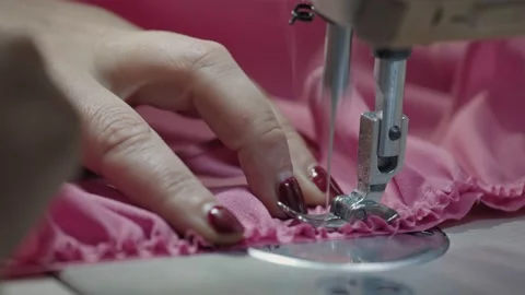 Close up working on sewing machine stitching side of fabric on a sewing machine Stock Footage 231015305