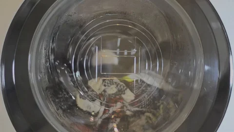 Close-up of working washing machine-spinning drum with clothes Stock Footage 86604667