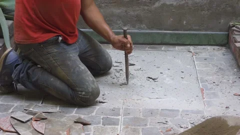Close-up of a workman breaking the floor of a house Stock Footage 150669329