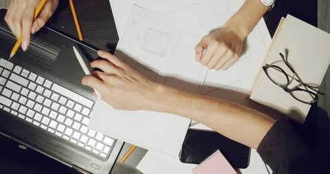 Close up of workplace of engineers or designers discussing project drawings Stock Footage 138526885