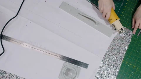 Close up Workplace of seamstress. Hands tailor cuts dress detail on the sketch Video stock 131065015