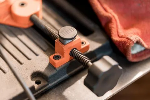 Close-up of a Workshop Clamping Tool with Textured Surface and Red Cloth 스톡 사진