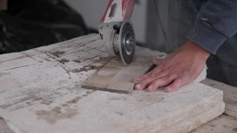 Close workshop scene of hand guiding circular saw through narrow wood plank on Stock Footage 344879114