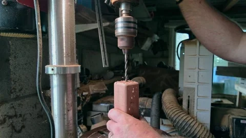 Close up of workshop worker drilling wooden block using precision pillar drill Stock Footage 336277216