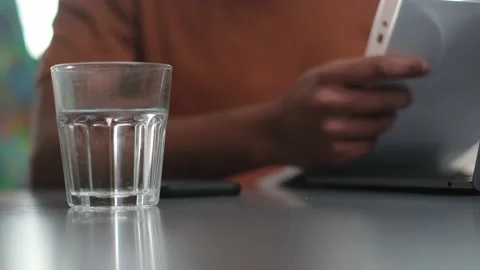 Close-up of workspace with handsome black man working with documents. Stock Footage 151888124