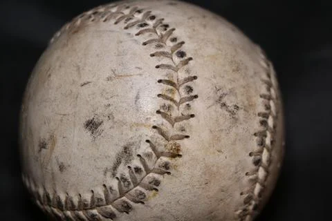 Close-Up of Worn Baseball on Dark Background Stock Photos