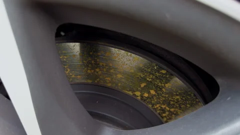 Close-up of worn brake disc behind wheel spokes with rust, surface wear, and 스톡 동영상 346558185