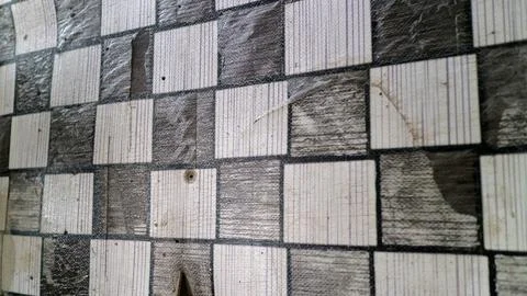 Close Up of Worn Checkered Patterned Wall Surface Stock Photos