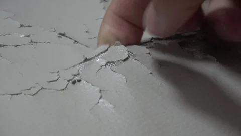 A close-up of worn, cracked leather on an old sofa. Hand picking worn surface. Stock Footage 329830766