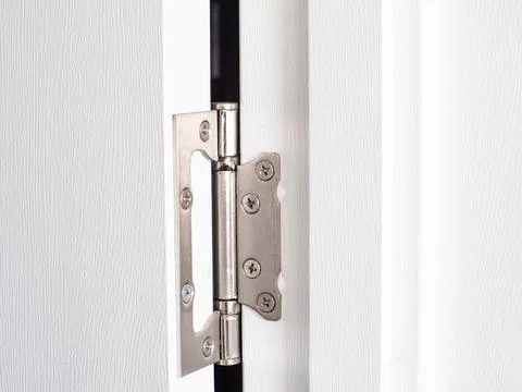 Close-up of a worn-out door hinge with steel attachments on door jamb Stock Photos