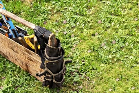A close-up of a worn toolbox with tools, including a used level, hammer, and Stock Photos