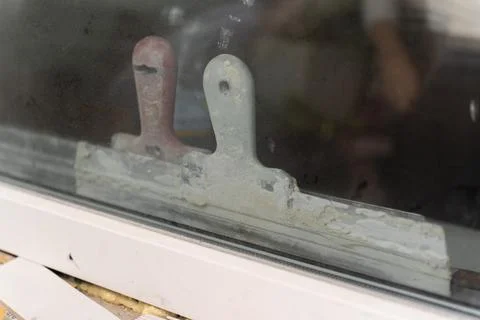 Close-up of a worn window handle and weathered frame with peeling paint, dust Stock Photos