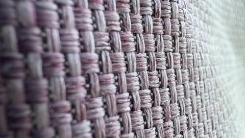 Close-up of a woven fabric texture with a mix of light and dark threads. The Video stock 322744043