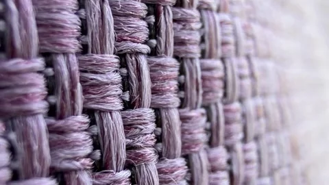 Close-up of woven fabric with a textured pattern. The material features a mix of Stock Footage 323438987